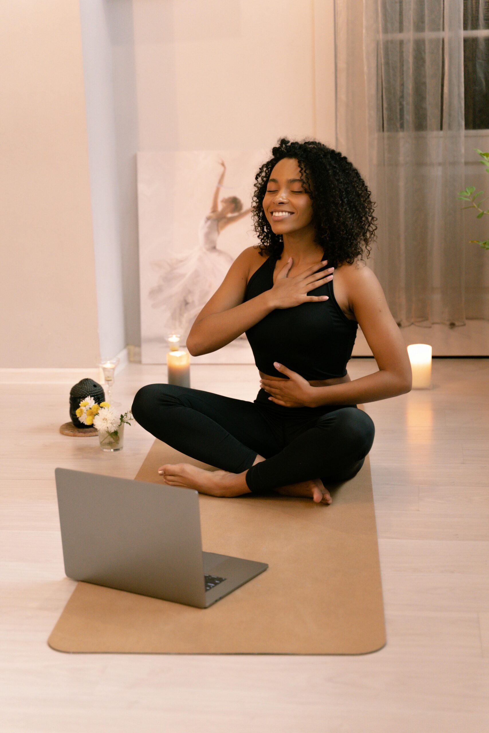 Yoga student meditating on her yoga mat, embracing personal growth and mindfulness.